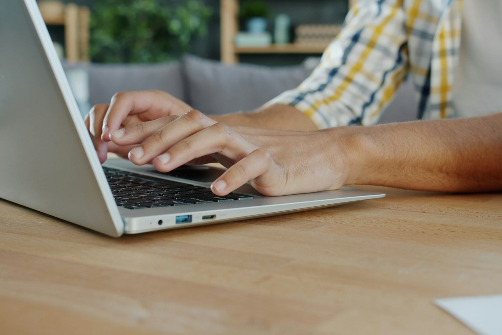 Hands typing on a laptop keyboard