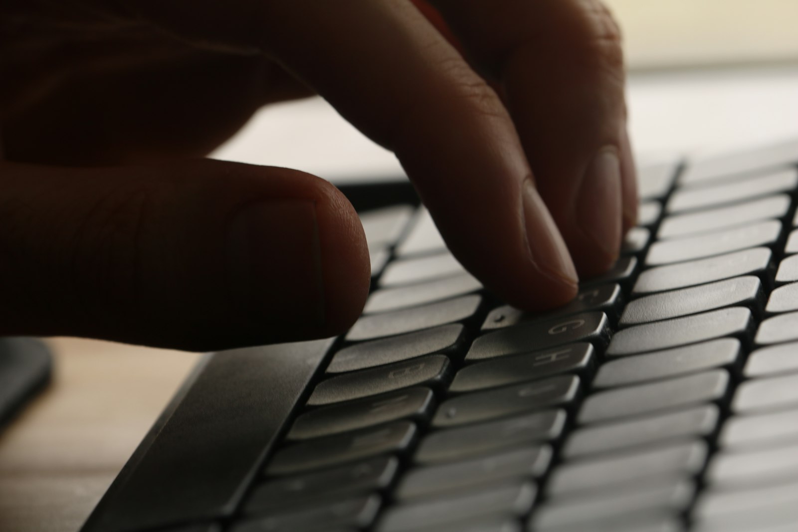 Close-up of hands typing on a keyboard