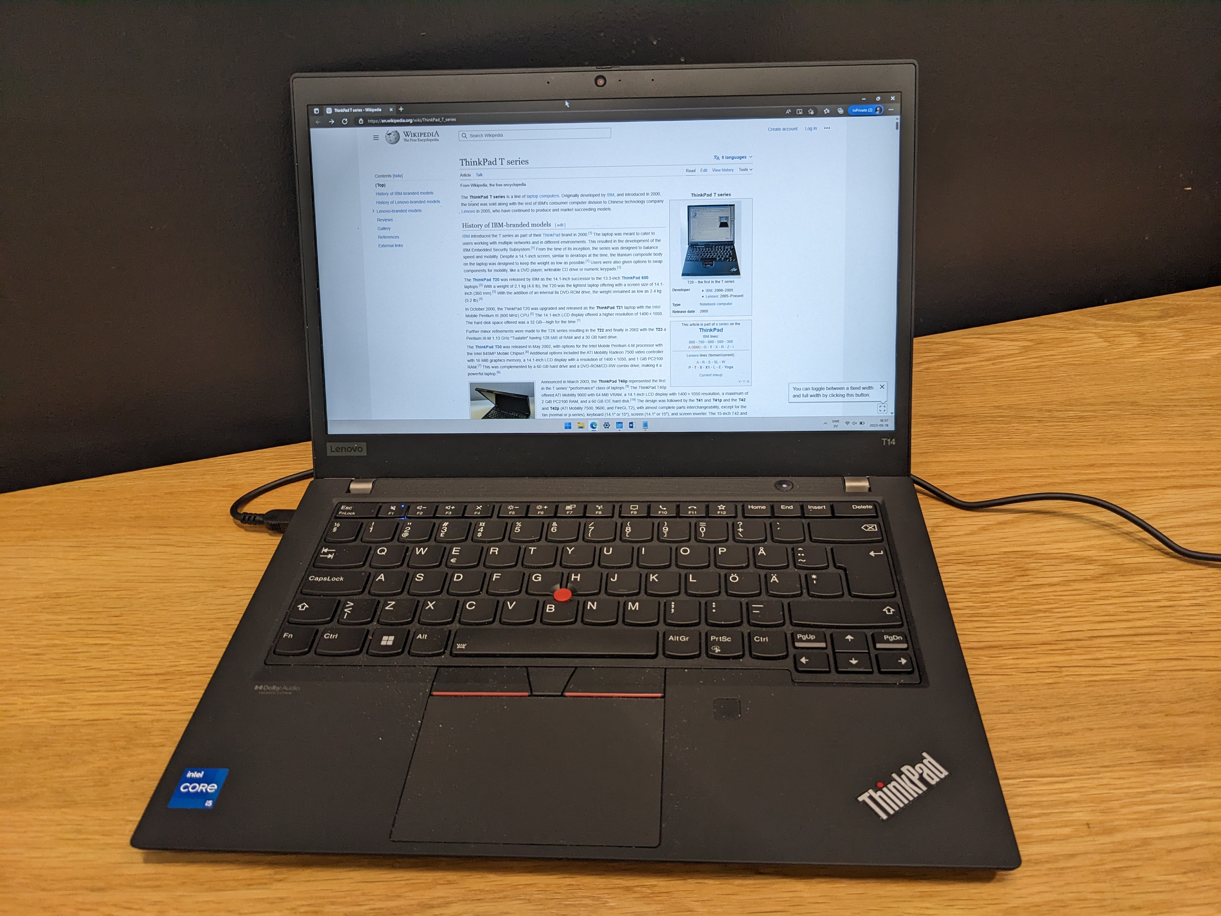 A Lenovo ThinkPad laptop, open, on a desk