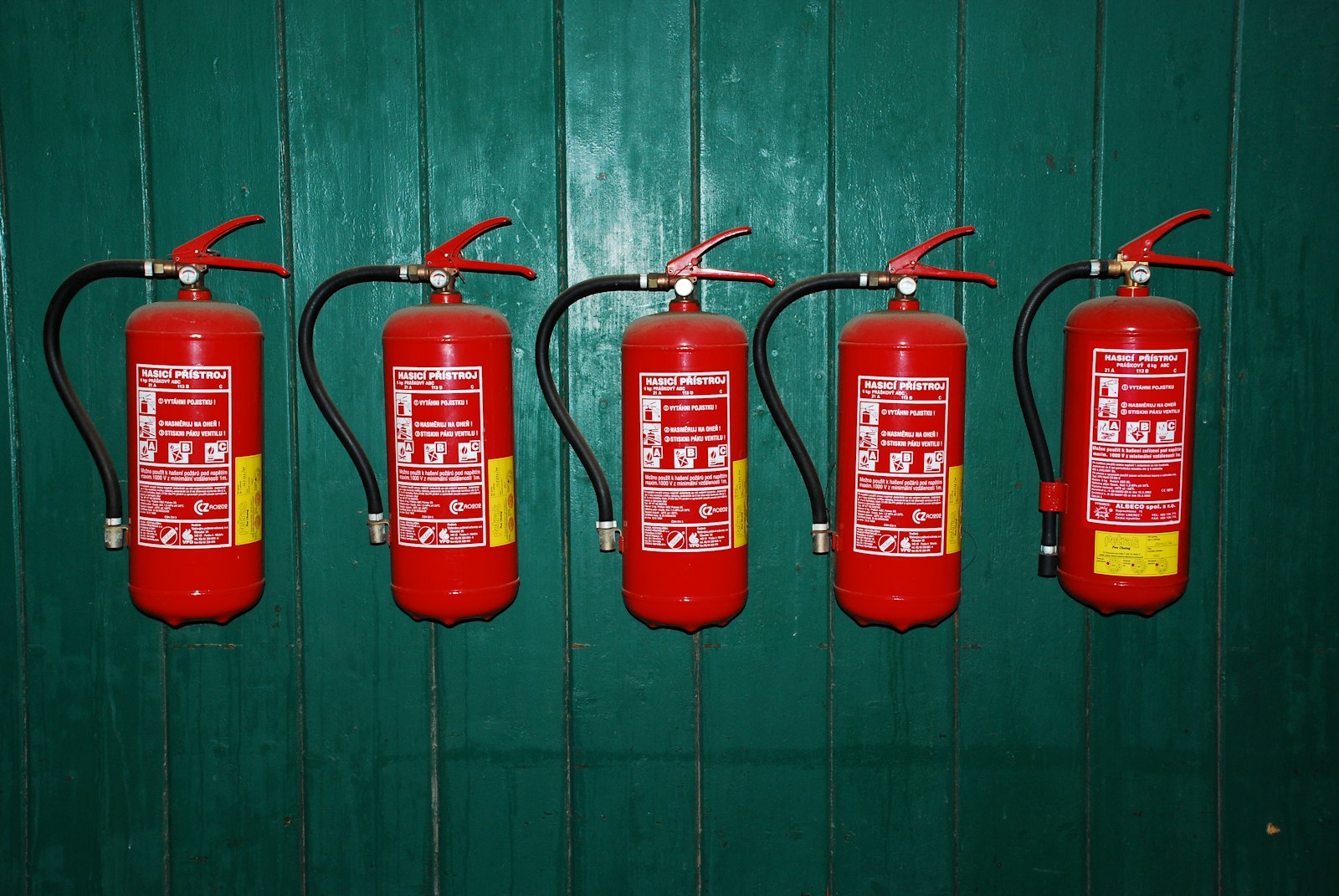 A row of fire extinguishers mounted on a wall