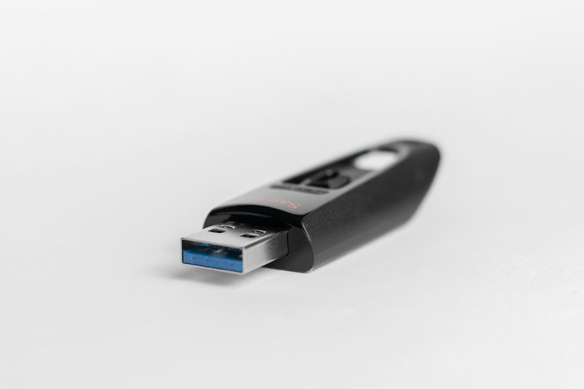 A black USB 3.0 flash drive with a blue connector